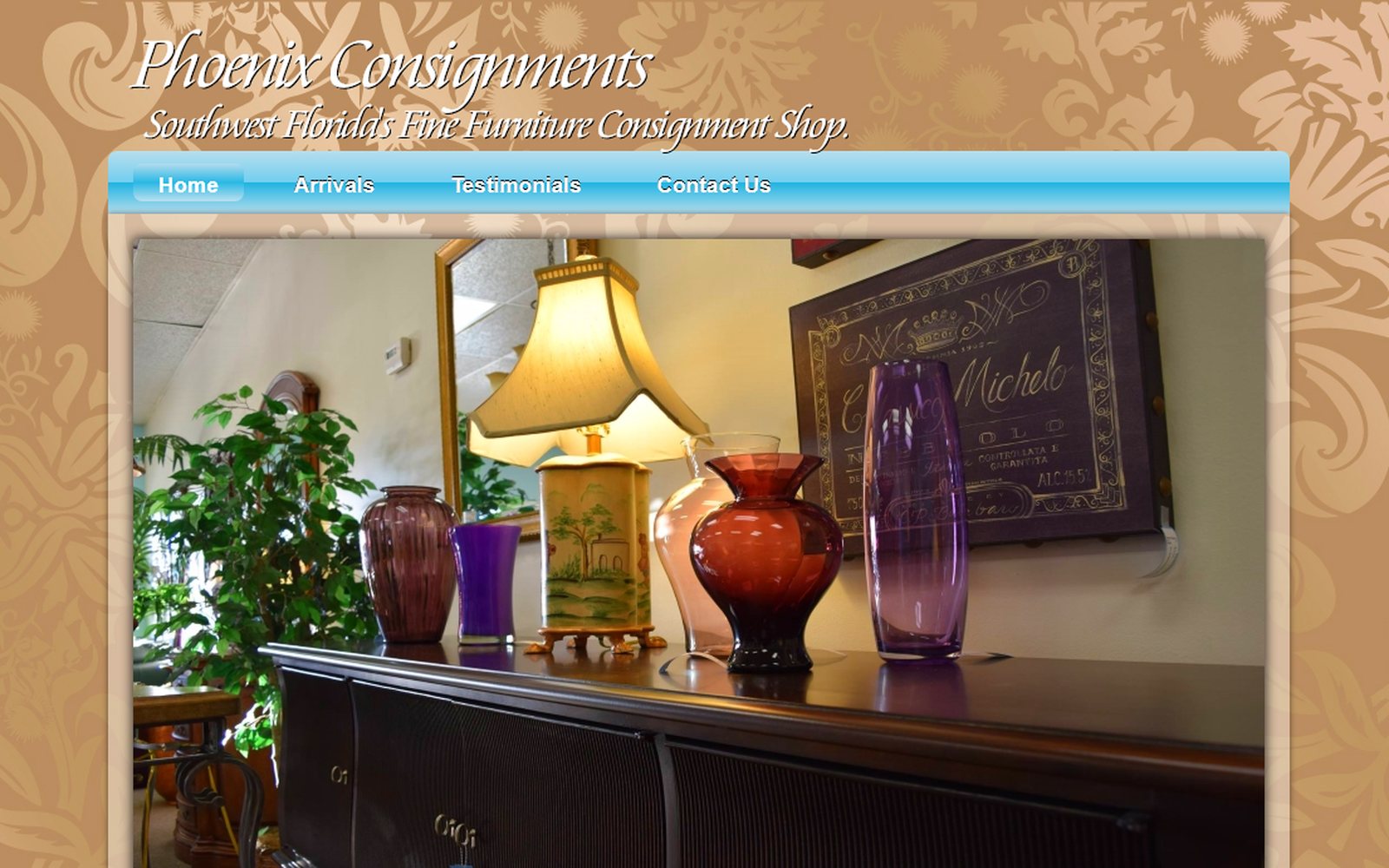 Phoenix Consignments website: warm gold and floral background, decorative photo of coloured glass vases on a sideboard.